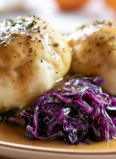Creamy German potato dumplings served with sauce and herbs