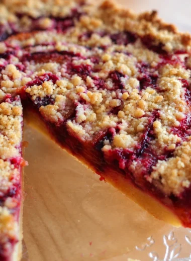 Classic German Zwetschgenkuchen topped with streusel, made with Italian plums.