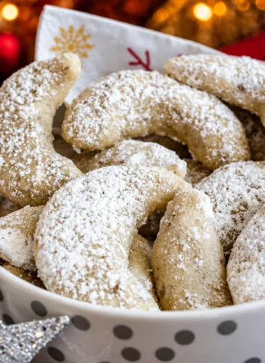 Easy German Vanillekipferl cookies dusted with vanilla sugar, a festive holiday treat.