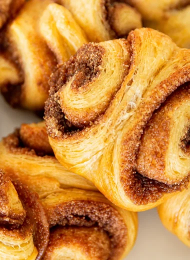 Traditional German Franzbrötchen, flaky cinnamon pastry rolls with buttery layers.