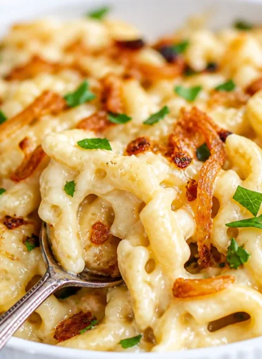 Warm bowl of comforting German Käsespätzle with cheese and caramelized onions.