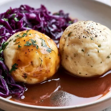 Traditional German Kartoffelklöße served with gravy and herbs