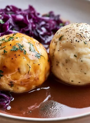 Traditional German Kartoffelklöße served with gravy and herbs