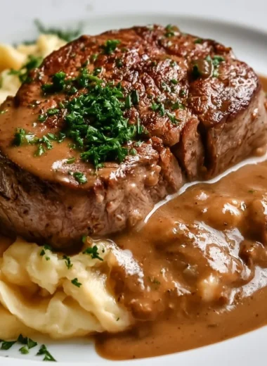 Delicious traditional Rahmschnitzel served with creamy sauce and herbs